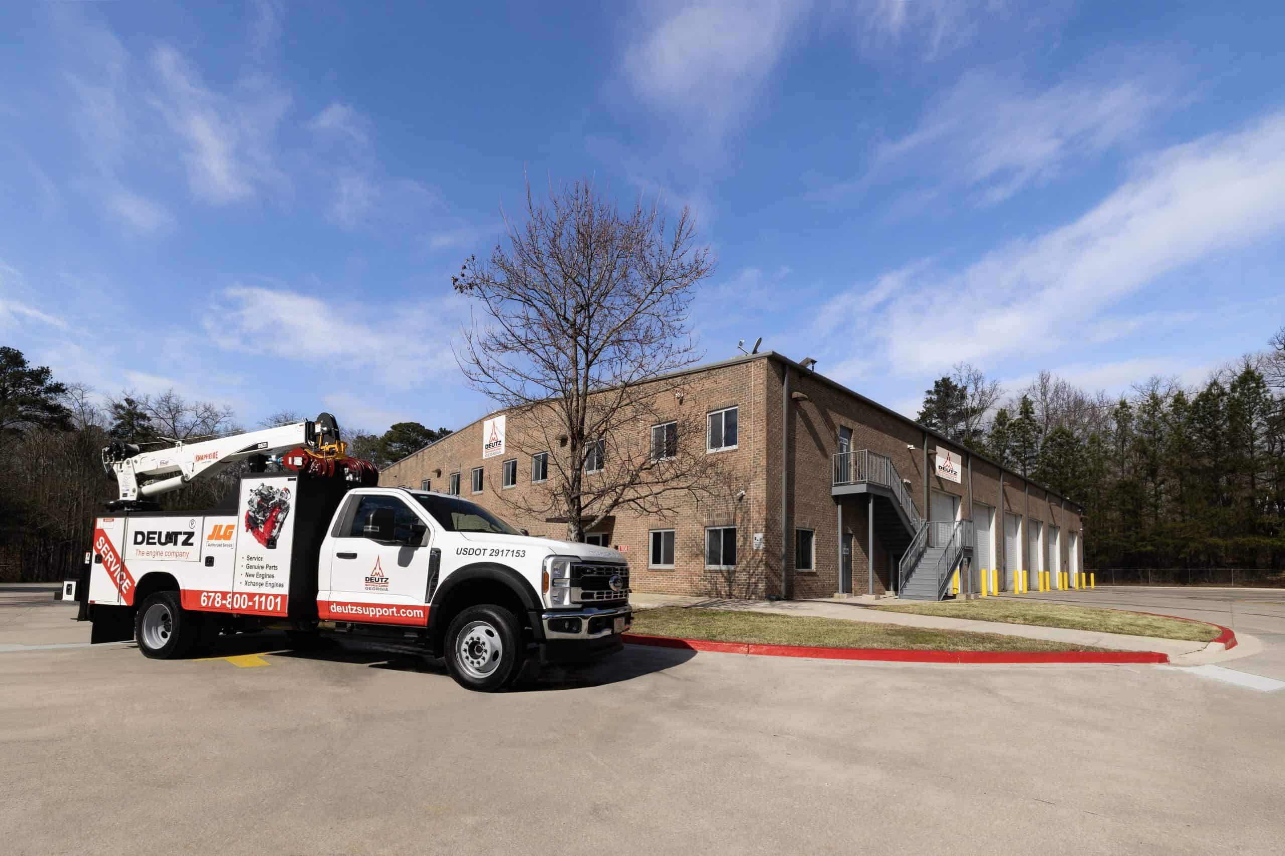 Service truck outside brick industrial building