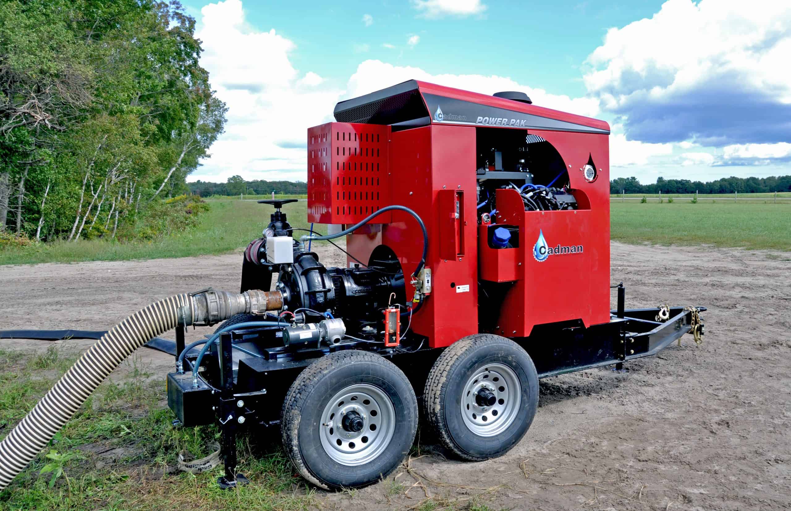 Red industrial pump trailer in rural field