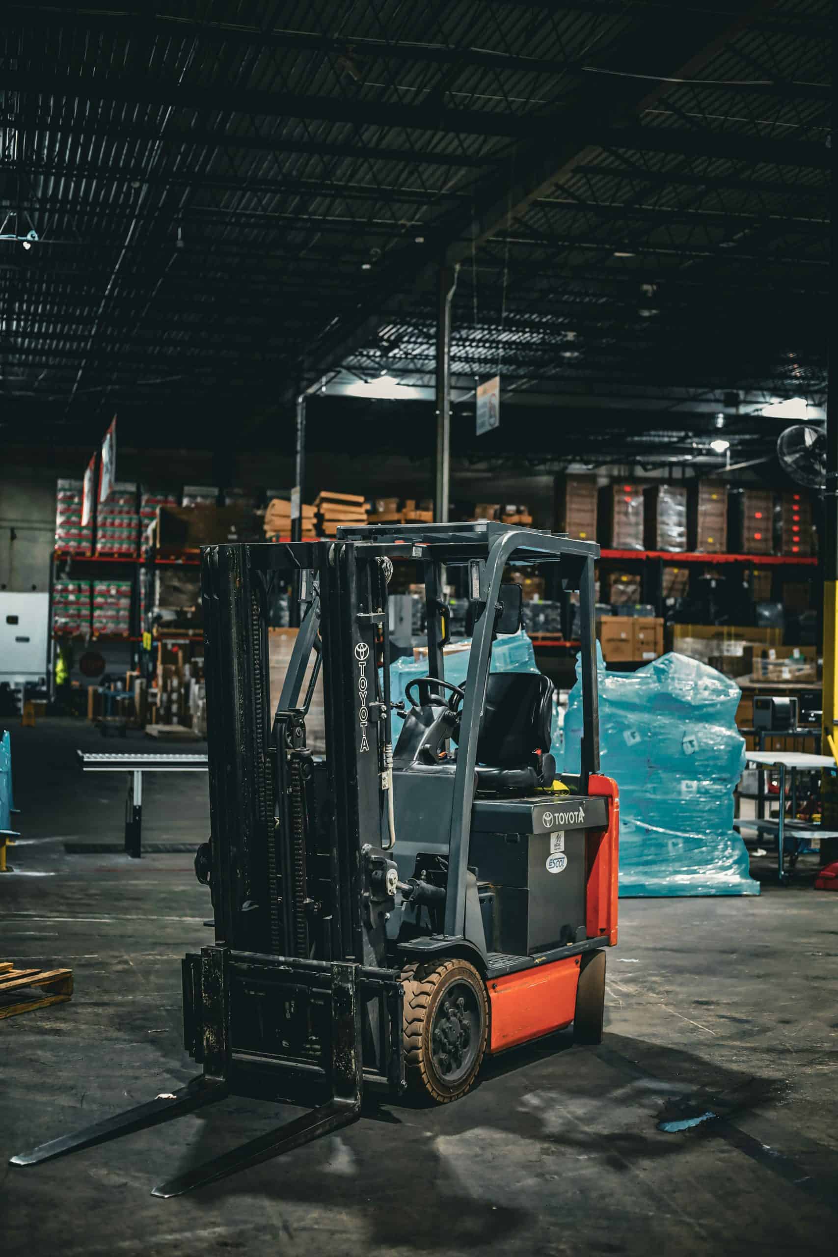 Forklift parked inside large warehouse facility